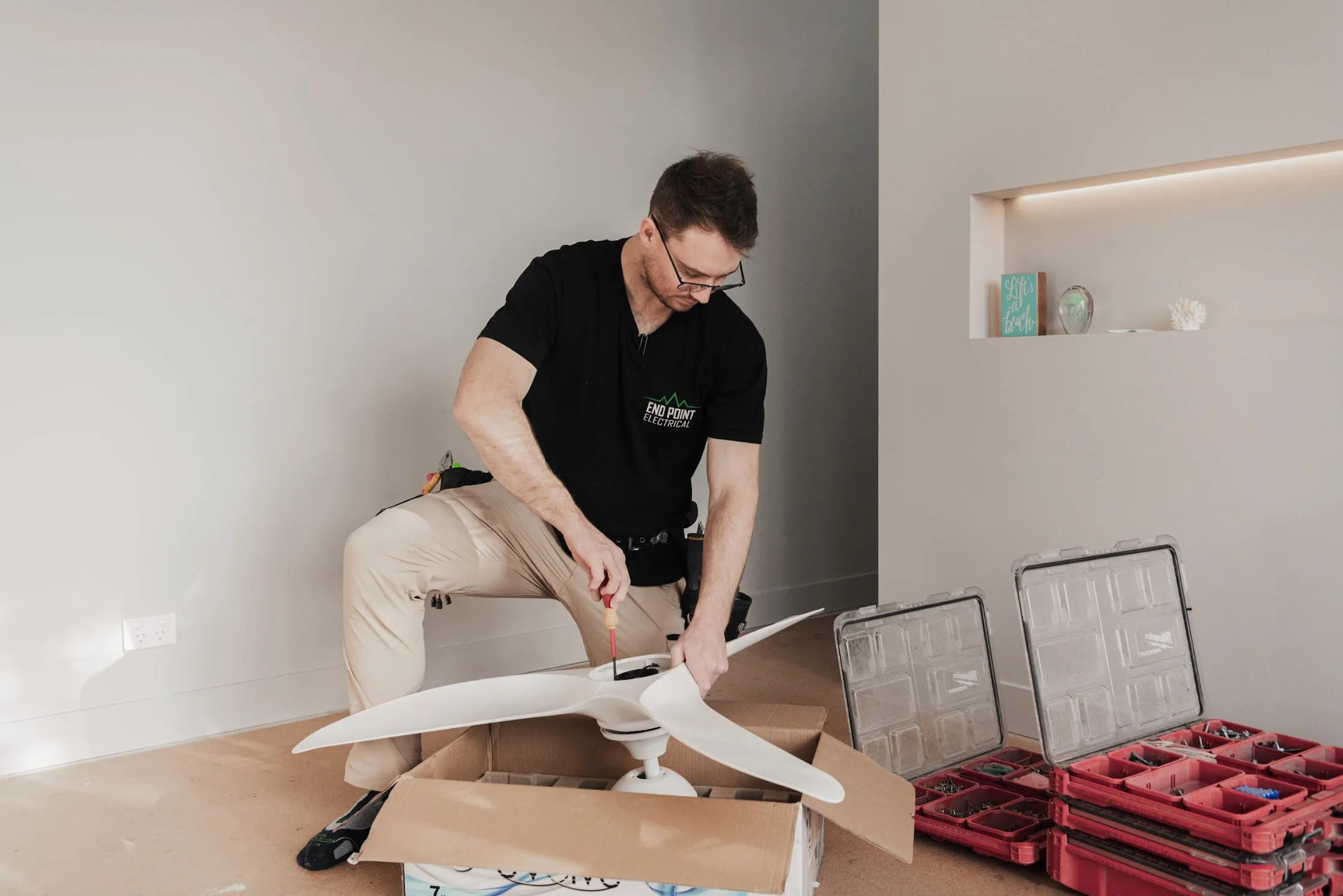 End Point Electrical electrician assembling a ceiling fan in a Sydney home